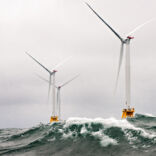 a group of wind turbines in the ocean