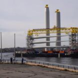 an image of a dock with a large structure in the ocean