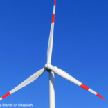 close up image of the top half of a wind turbine framing just the blades